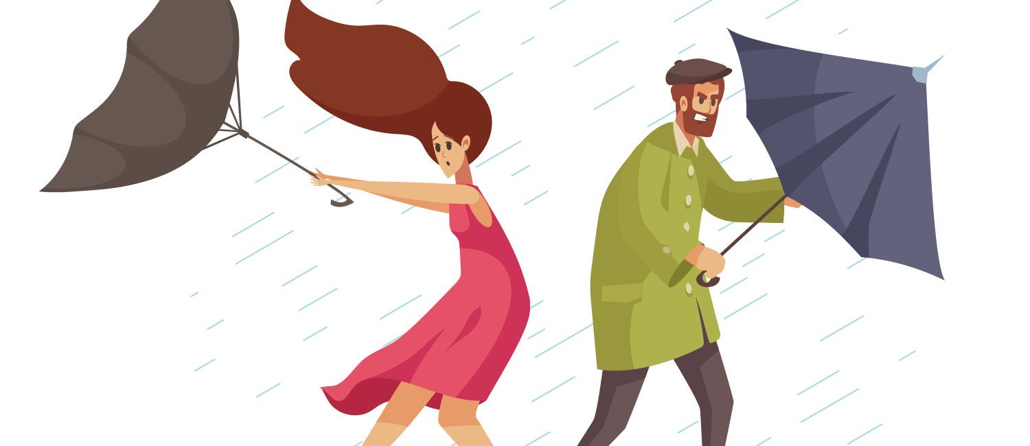 Mężczyzna i kobieta trzymający parasole targane wiatrem